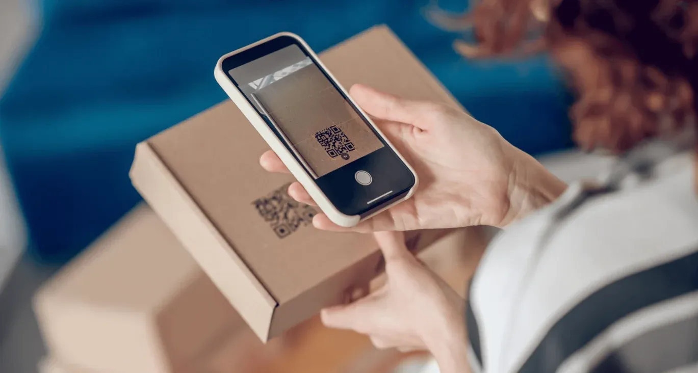 Woman scanning QR code on a product packaging